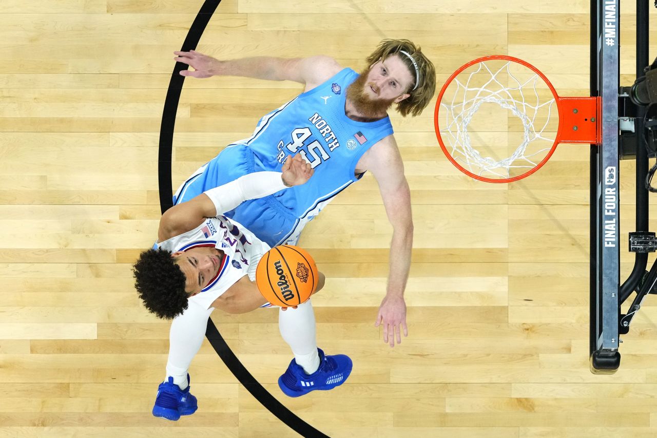 North Carolina's Brady Manek tries to take a charge while Kansas' Jalen Wilson drives to the basket on Monday, April 3. Manek, however, was called for a block. <a href="http://www.cnn.com/2022/04/04/sport/gallery/kansas-north-carolina-ncaa-mens-final-photos/index.html" target="_blank">See more photos from the national championship game.</a>