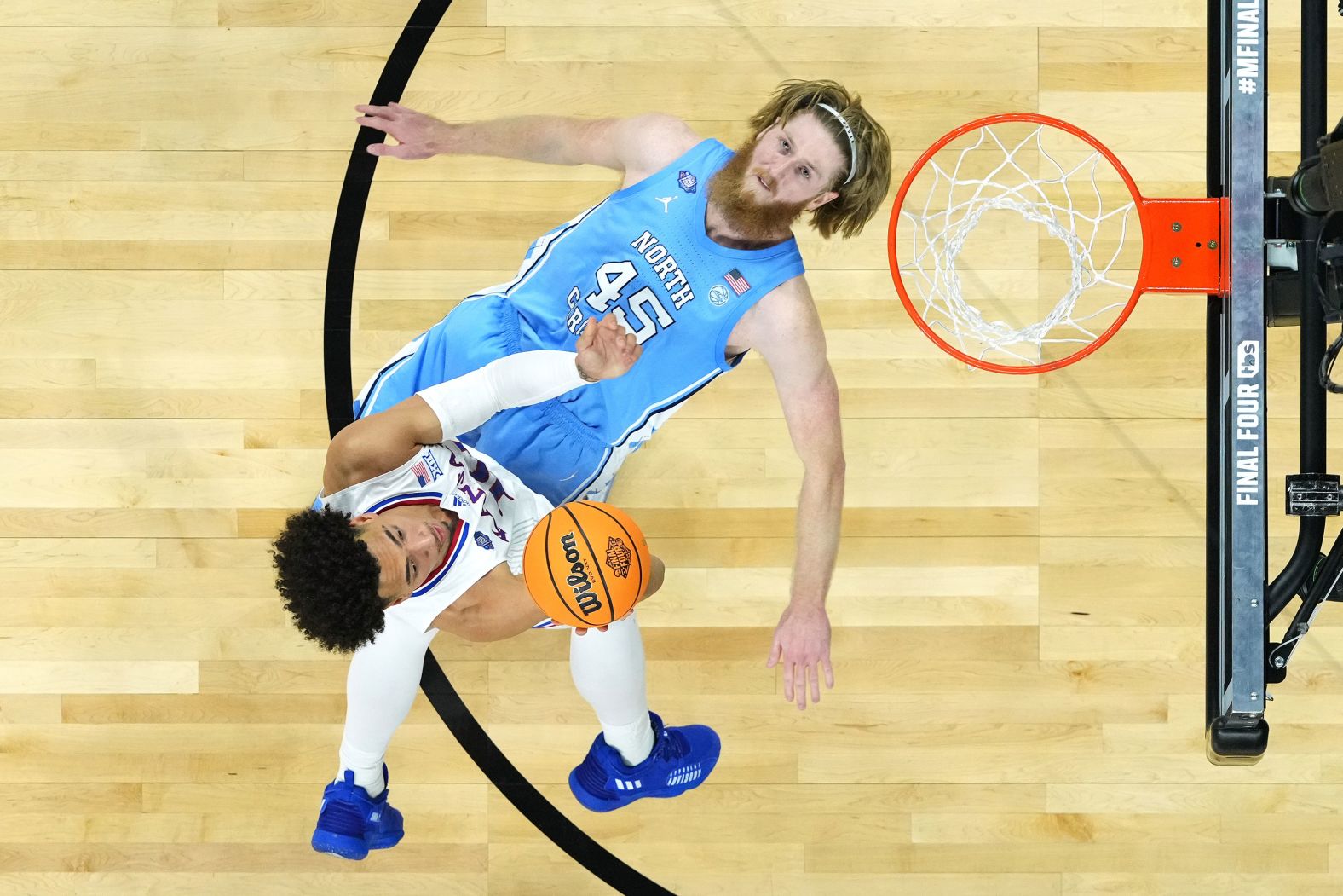 North Carolina's Brady Manek tries to take a charge while Kansas' Jalen Wilson drives to the basket on Monday, April 3. Manek, however, was called for a block. <a href="index.php?page=&url=http%3A%2F%2Fwww.cnn.com%2F2022%2F04%2F04%2Fsport%2Fgallery%2Fkansas-north-carolina-ncaa-mens-final-photos%2Findex.html" target="_blank">See more photos from the national championship game.</a>