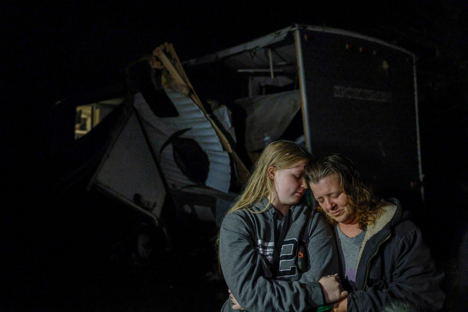 Brittaney Deaton comforts her mother, Amber Zeleny, after a tornado ripped through their property near Egan, Texas, on Tuesday, April 5. Deaton's father, Shawn Zeleny, was injured as he rescued his daughter from a trailer just outside the family home, <a href="index.php?page=&url=https%3A%2F%2Fwww.star-telegram.com%2Fnews%2Fweather-news%2Farticle260129195.html" target="_blank" target="_blank">according to the Fort Worth Star-Telegram.</a>