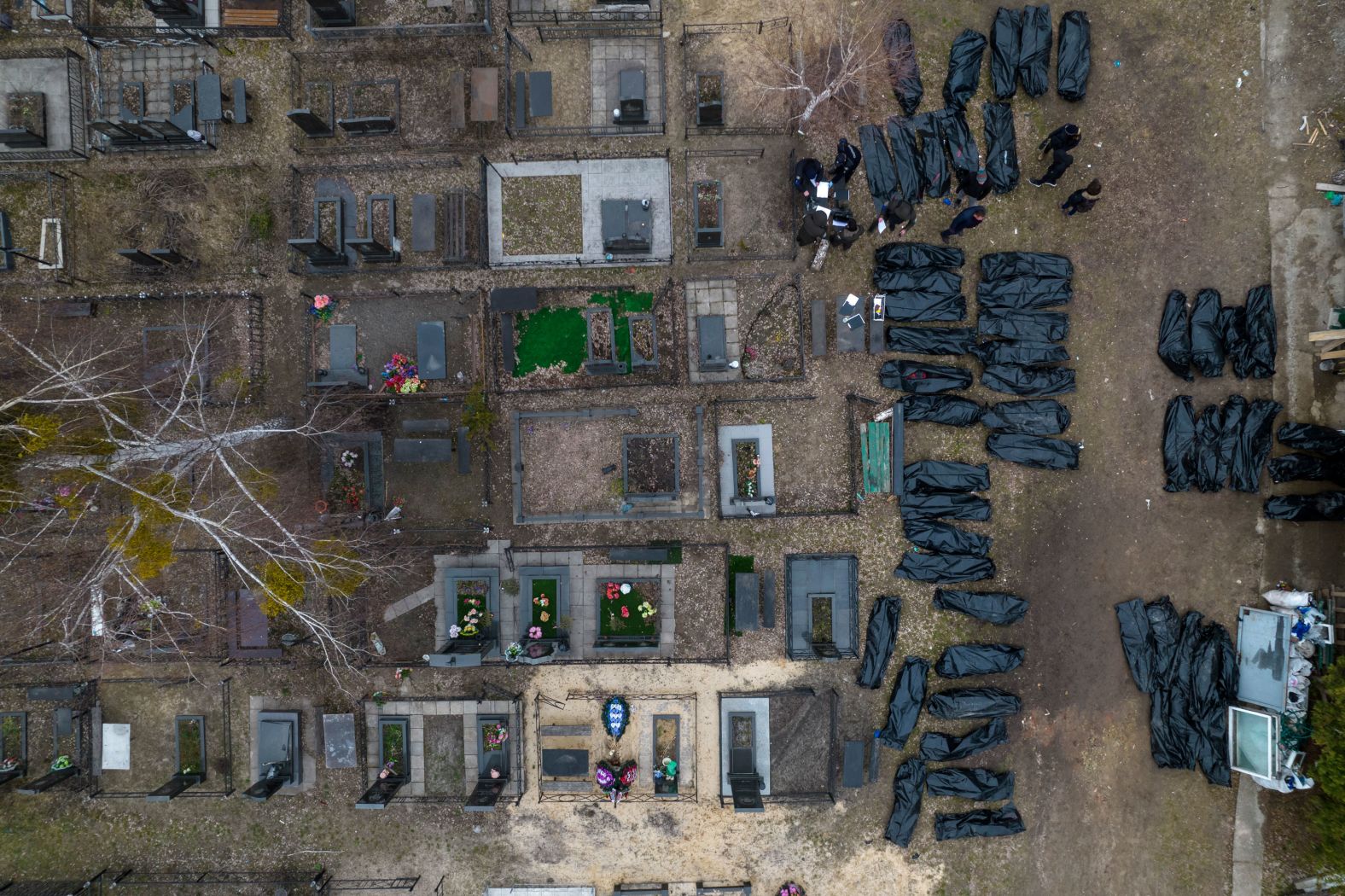 Body bags are seen in Bucha, Ukraine, as police officers work to identify the dead on Wednesday, April 6. The suburb's name has become a byword for war crimes this week after <a href="index.php?page=&url=https%3A%2F%2Fwww.cnn.com%2F2022%2F04%2F05%2Feurope%2Fbucha-ukraine-russian-occupation-reality-intl-cmd%2Findex.html" target="_blank">accounts of summary executions, brutality and indiscriminate shelling</a> emerged in the wake of Russia's hasty retreat.