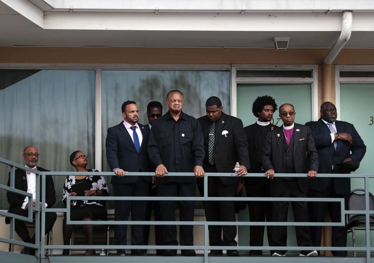 The Rev. Jesse Jackson, center, takes a moment to reflect Monday, April 4, at the spot where <a href="https://www.cnn.com/interactive/2018/04/us/martin-luther-king-jr-cnnphotos/" target="_blank">Martin Luther King Jr.</a> was fatally shot in Memphis, Tennessee, in 1968.