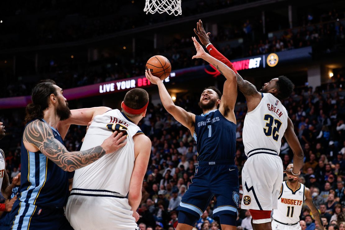 Grizzlies forward Kyle Anderson drives to the net against Jeff Green as Jokic and center Steven Adams battle for position.