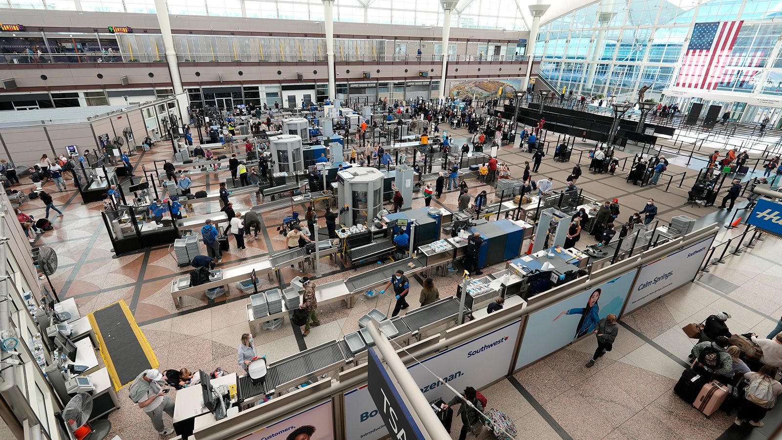 <strong>No. 3 Denver International Airport:</strong> Travelers line up at a security checkpoint on December 26, 2021. US airports dominate the 2021 list thanks to a strong rebound in domestic flights. 