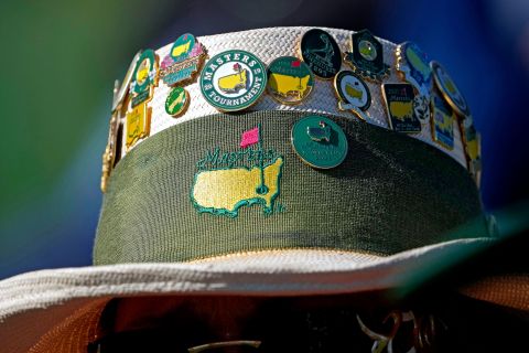 Masters pins adorn a fan's hat on Friday.