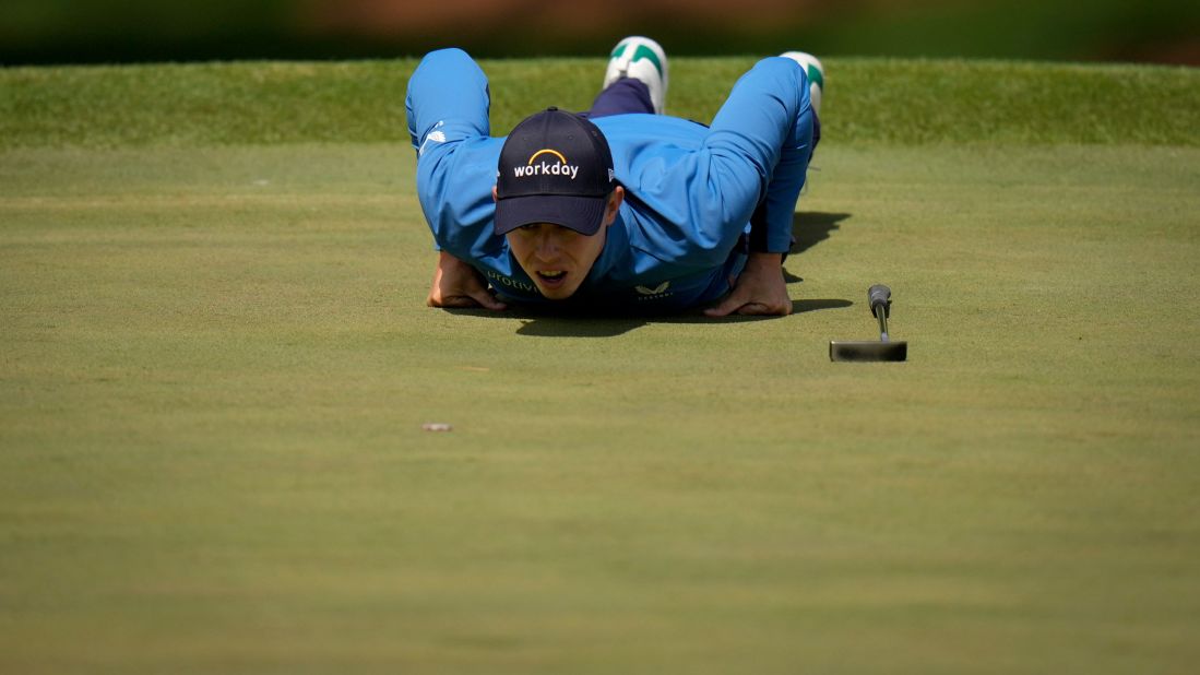 Matthew Fitzpatrick lies on the seventh green to visualize a putt on Friday.