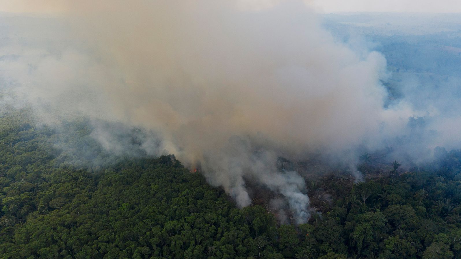 Smoke rises from a fire in the Amazon rainforest in Ruropolis, Brazil on November 29, 2019. 