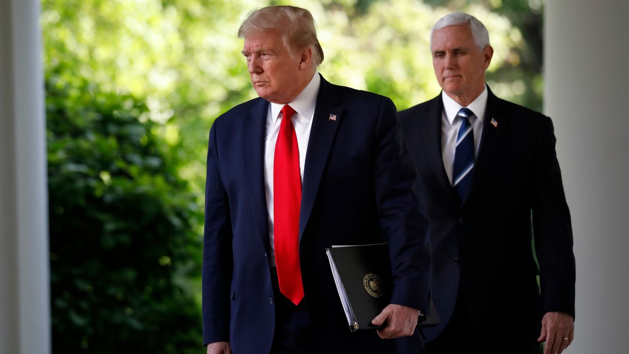 President Donald Trump and Vice President Mike Pence arrive at a news conference in the Rose Garden of the White House on April 27, 2020. 