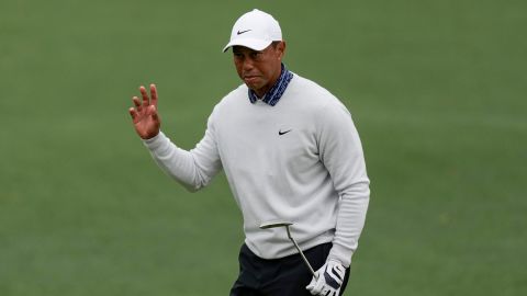 Woods waves after a birdie putt on the second hole during the third round at the Masters.