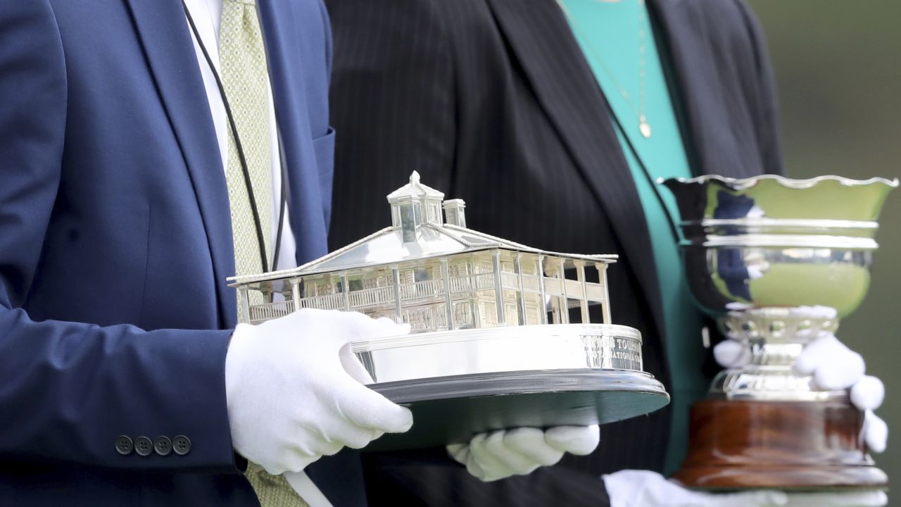 The Masters trophy (left) and the amateur trophy are brought out to be presented following the Masters.