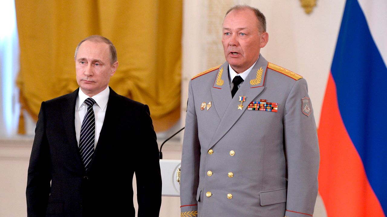 In this pool photo taken on Thursday, March 17, 2016, Russian President Vladimir Putin, left, poses with Col. Gen. Alexander Dvornikov during an awarding ceremony in Moscow's Kremlin, Russia.