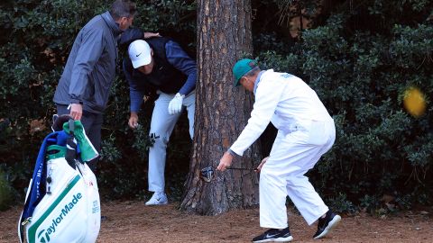 Scheffler prepares to take a drop on the 18th hole during the third round of the Masters.