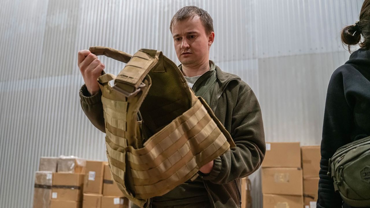 A Ukrainian civil defender holding a vest that was provided by the Ukrainian American Coordinating Council after one of the shipments of donations arrived in Ukraine.