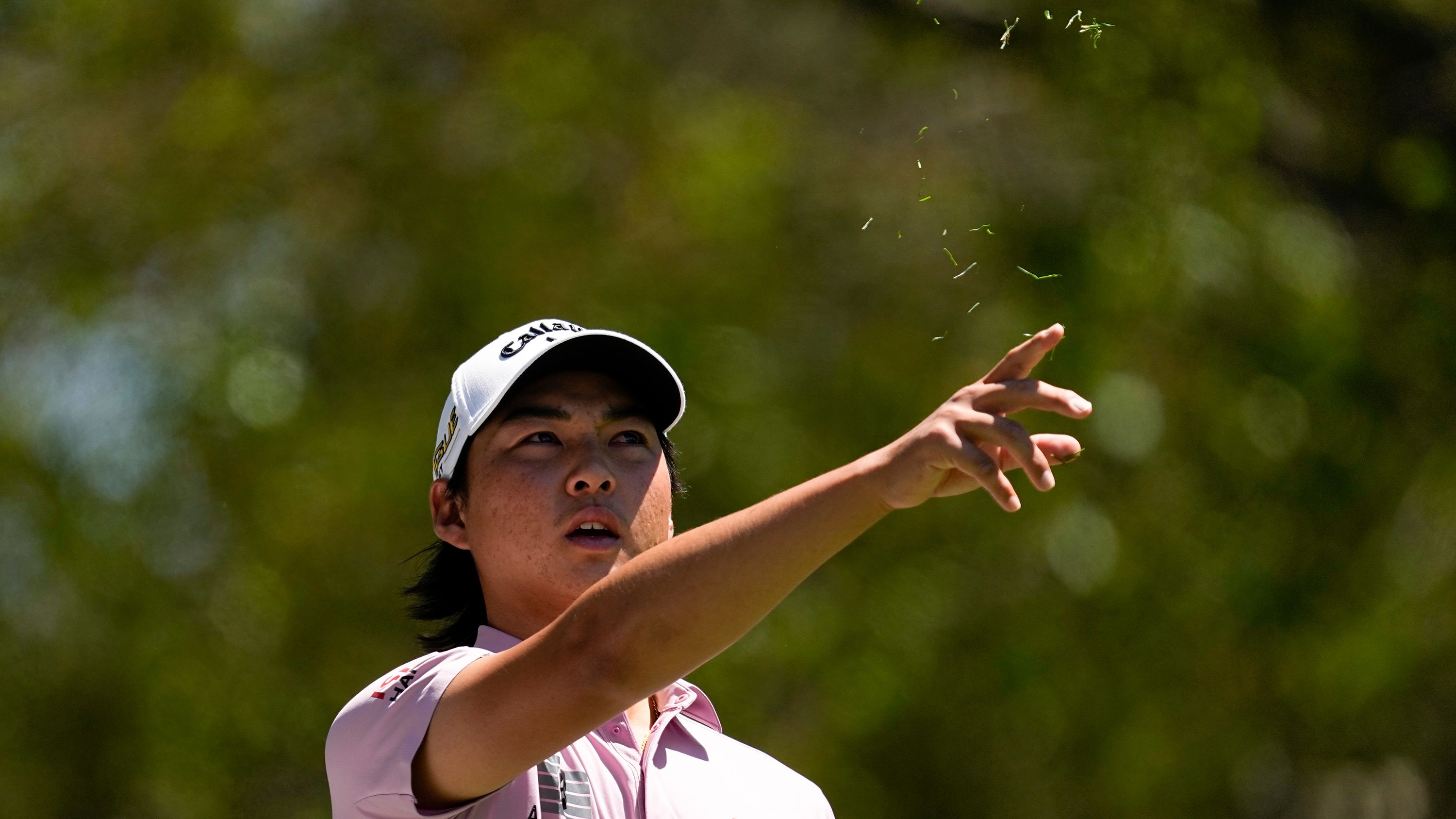 Min Woo Lee tests the wind before teeing off on the fourth hole Sunday.