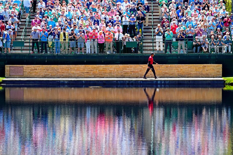 Woods crosses the Sarazen Bridge on the 15th hole Sunday.