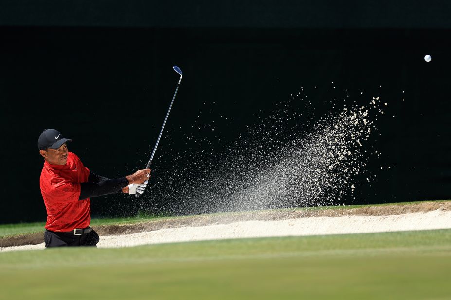 Tiger Woods plays a shot from the bunker on the third hole Sunday. He shot a 78 for the second straight day, his worst score ever at the Masters. 