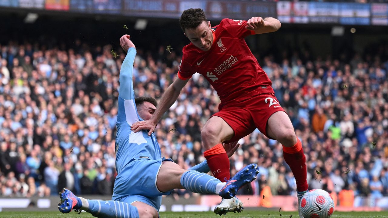 Manchester City's French defender Aymeric Laporte tackles Liverpool's Portuguese striker Diogo Jota during the Premier League match between Manchester City and Liverpool.