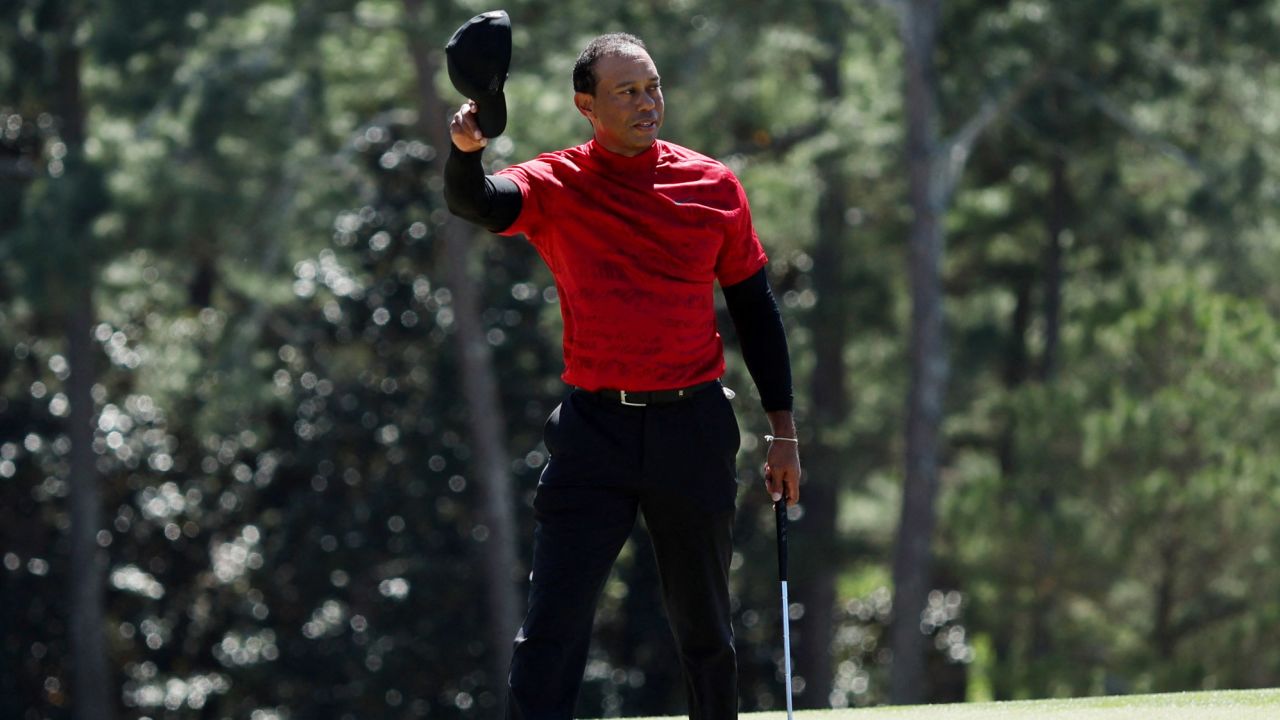 Woods salutes the patrons on the 18th green during the final round of the Masters. 