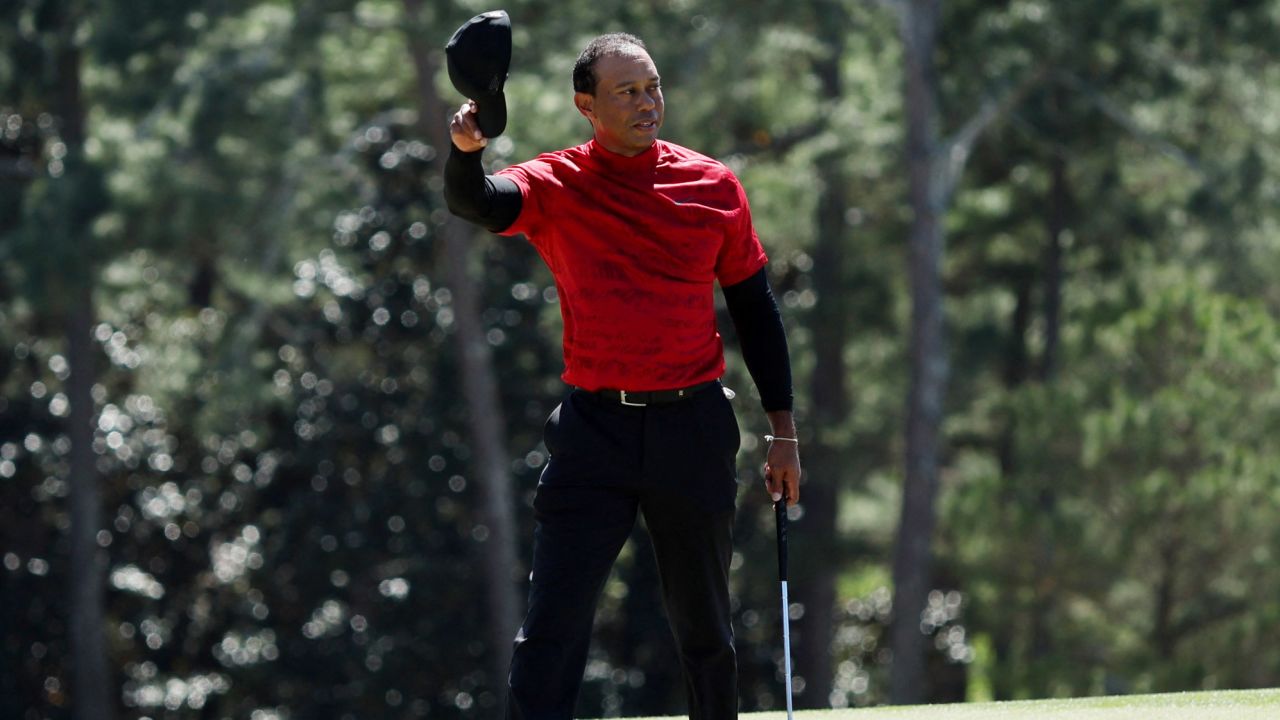 Woods salutes the patrons on the 18th green during the final round of the Masters.