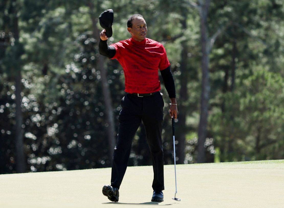 Woods salutes the patrons on the 18th green during the final round of the Masters. 