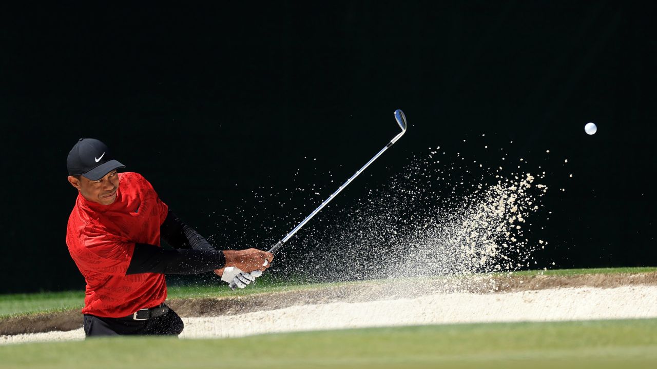 Woods plays his shot from the bunker on the fourth hole during the final round of the Masters.