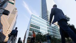 Office workers walk near the Goldman Sachs Group Inc. headquarters in New York, U.S., on Thursday, July 22, 2021.