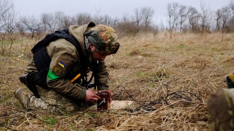 Lt. Col. Mykola Opanasenko prepares to blow up 16 unexploded Russian artillery shells.