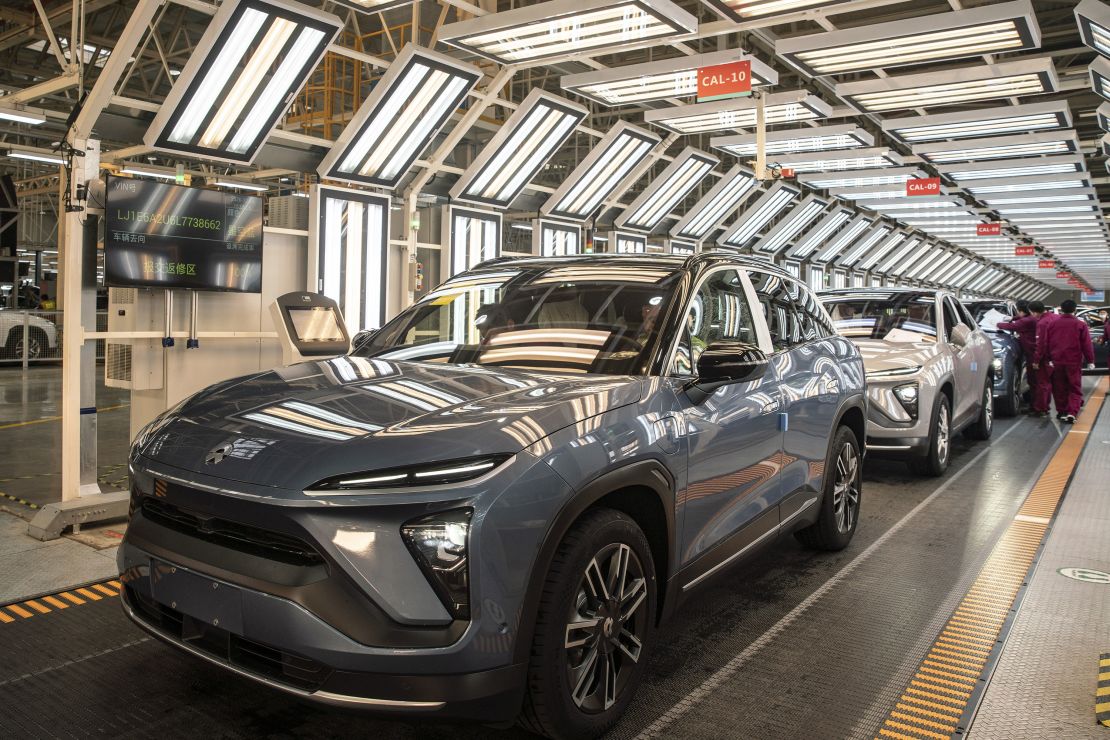 Employees make checks at an inspection line during a media tour of the Nio Inc. production facility in Hefei, Anhui province, China, on Friday, Dec. 4, 2020.?