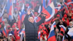 Russian President Vladimir Putin greets the audience as he attends a concert marking the eighth anniversary of Russia's annexation of Crimea at the Luzhniki stadium in Moscow on March 18, 2022.