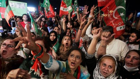 Supporters of the Pakistan Tehreek-e-Insaf (PTI) political party wave flags and chant in support of former Pakistani Prime Minister Imran Khan in Lahore, Pakistan April 10, 2022.