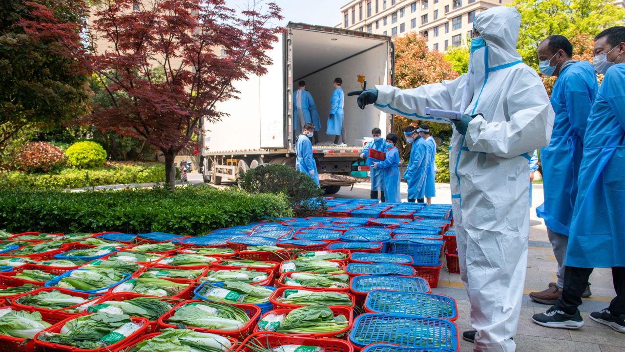 A community volunteer examines vegetables to be distributed to residents under lockdown in Pudong district in Shanghai on April 12.