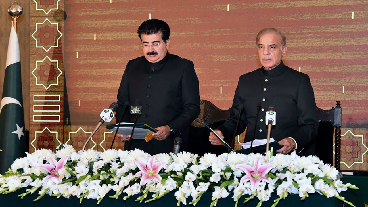 Acting President of Pakistan Sadiq Sanjrani, left, administers the oath of office to newly elected Pakistani Prime Minister Shehbaz Sharif at the Presidential Palace in Islamabad on April 11. 