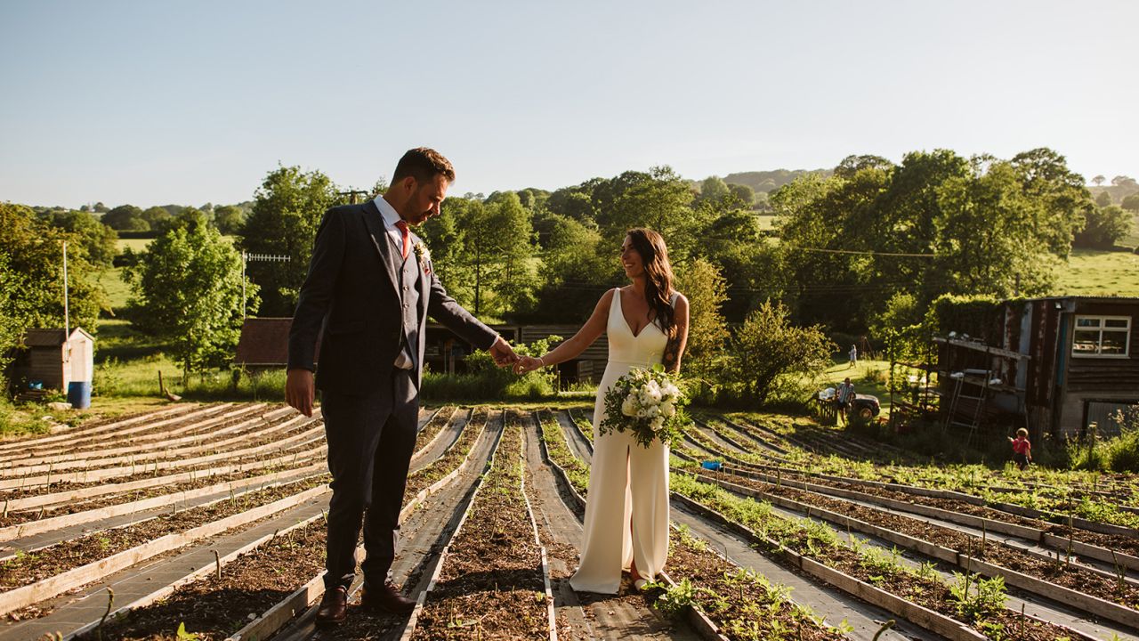 The couple, seen here in Gostling's asparagus field, hosted a small outdoor ceremony for 12 people and then a larger celebration in September 2021. 