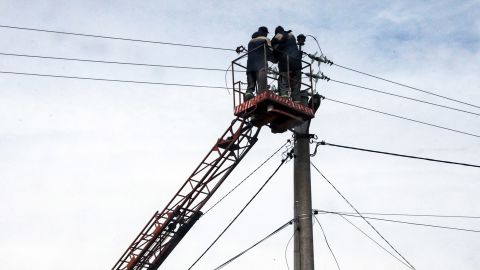 Communal workers repair power lines in Hostomel, Kyiv Region, Ukraine.