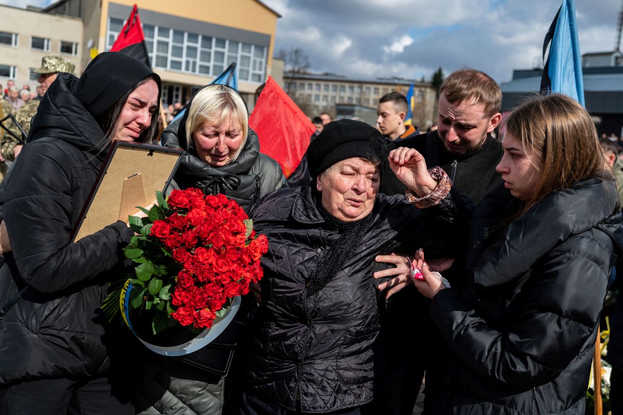 Mourners react in Stebnyk, Ukraine, during the funeral ceremony of Ukrainian serviceman Roman Tiaka. Tiaka was 47.
