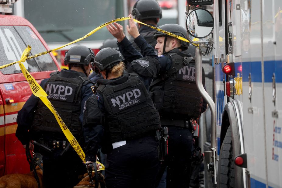 Police officers work near the scene of the shooting.