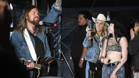 Tish Cyrus (third from right) takes a photo of Billy Ray Cyrus (left) backstage during the 2019 Stagecoach Festival at Empire Polo Field on April 28, 2019, in Indio, California.