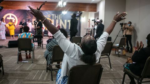 A church member raises his hands in worship during an Easter Sunday service at New Mount Calvary Missionary Baptist Church on Sunday, April 4, 2021, in Los Angeles.