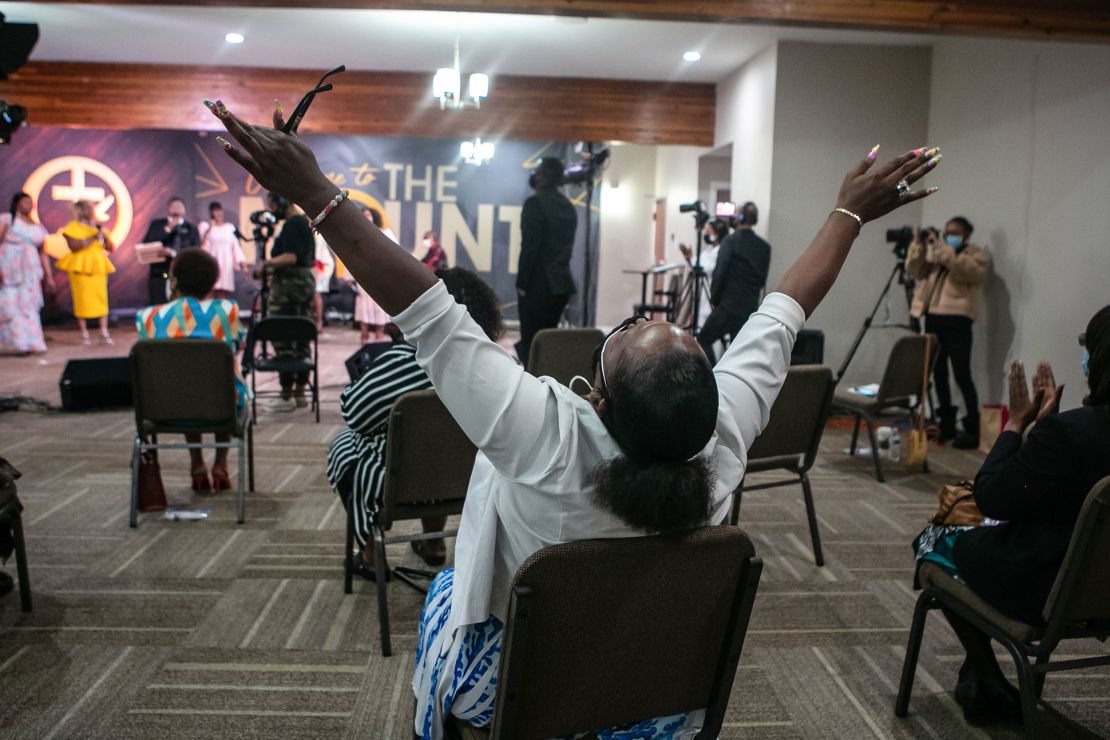 A church member raises his hands in worship during an Easter Sunday service at New Mount Calvary Missionary Baptist Church on Sunday, April 4, 2021, in Los Angeles.