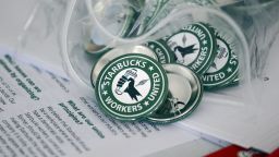 Pro-union pins sit on a table during a watch party for Starbucks' employees union election, Dec. 9, 2021, in Buffalo, N.Y.  