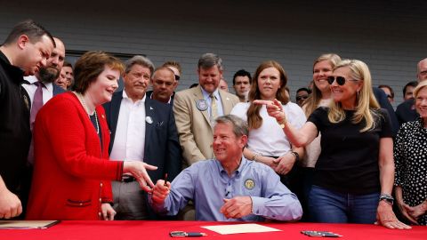 Gov. Brian Kemp signed the bill at a gun store in Douglasville Tuesday.