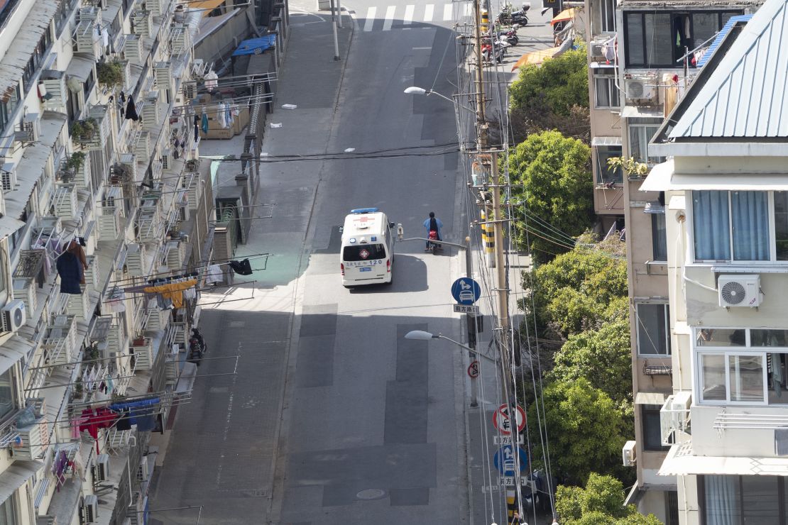 An ambulance runs through an empty street in Shanghai on April 8.
