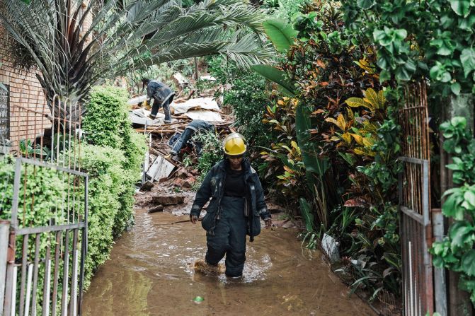 Members of the Ethekwini Metro Fire Department search for a person believed to be trapped after a mudslide caused a house to collapse in Durban on April 12.