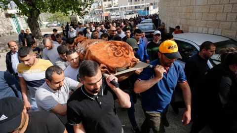Mourners carry the body of Ghada Sabateen during her funeral in the West Bank village of Husan on April 10. 
