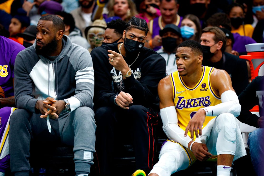 LeBron James, Anthony Davis and Russell Westbrook look on from the sidelines during the Lakers' game against the Charlotte Hornets at Spectrum Center on January 28, 2022 in Charlotte.