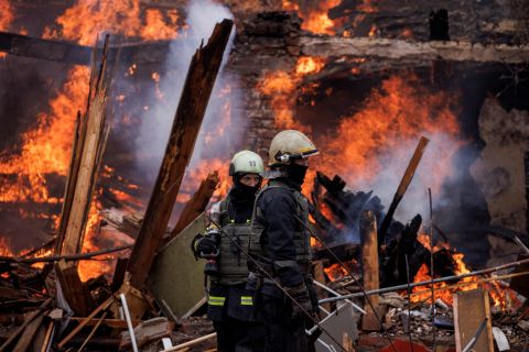 Firefighters work at a burning building in Kharkiv, Ukraine, following a missile attack near the Kharkiv International Airport on Tuesday, April 12.