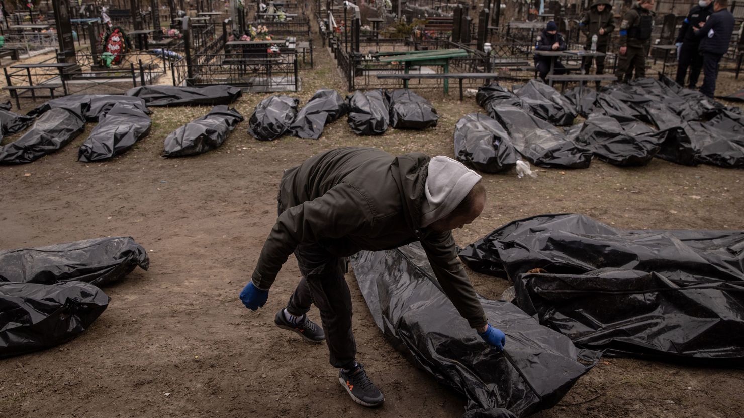 Police officers and forensic personnel catalog 58 bodies of civilians killed in and around Bucha before they are transported to the morgue at a cemetery on April 6, 2022, in Bucha, Ukraine. 