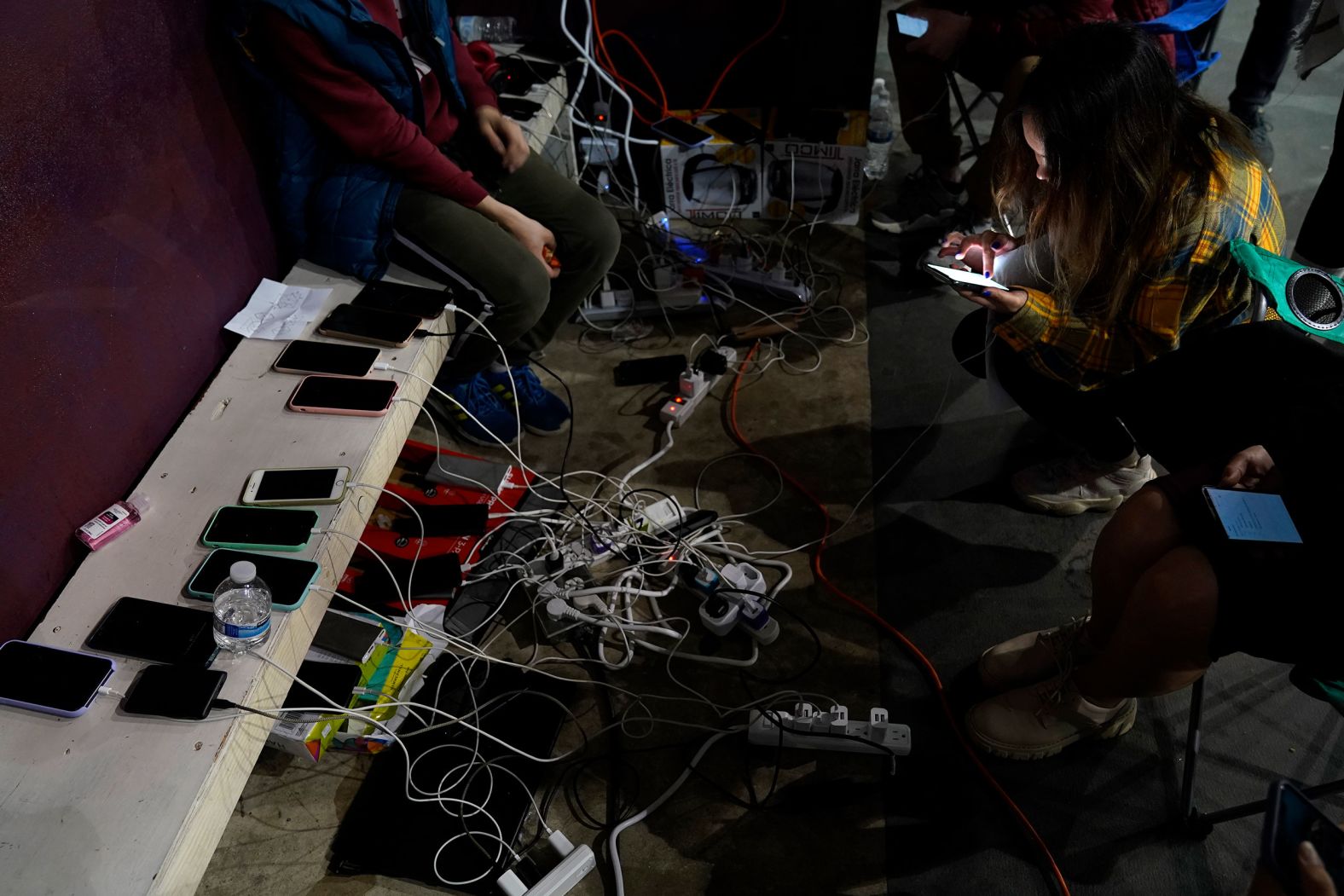 Ukrainians waiting to cross into the United States charge their phones at a gymnasium in Tijuana on April 5.