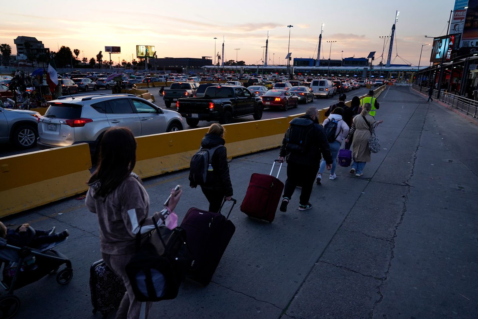 Ukrainians follow a volunteer to the San Ysidro Port of Entry as they prepare to cross into the United States on April 4.