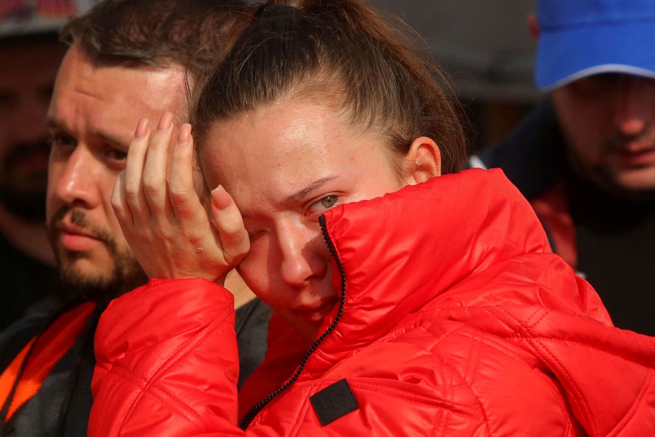A Ukrainian who fled her homeland amid Russia's invasion wipes tears from her eyes as she waits to cross into the United States on April 1.