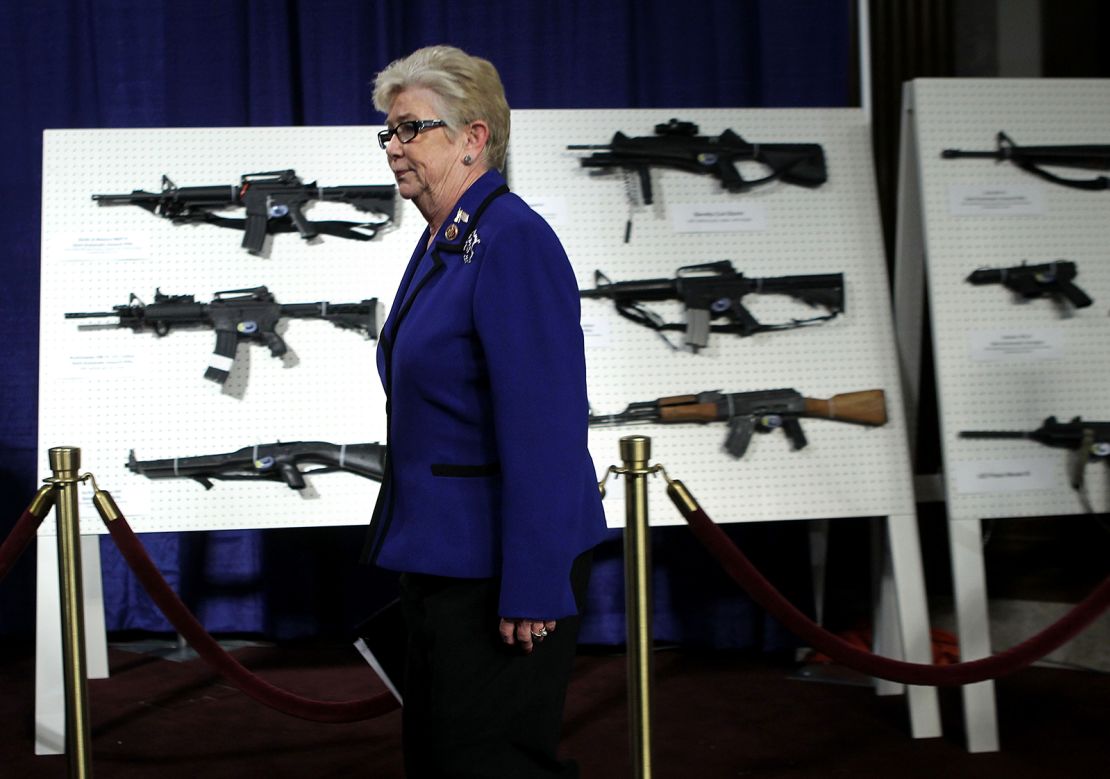 Former US Rep. Carolyn McCarthy passes by a display of assault weapons during a news conference January 2013 on Capitol Hill in Washington, DC.